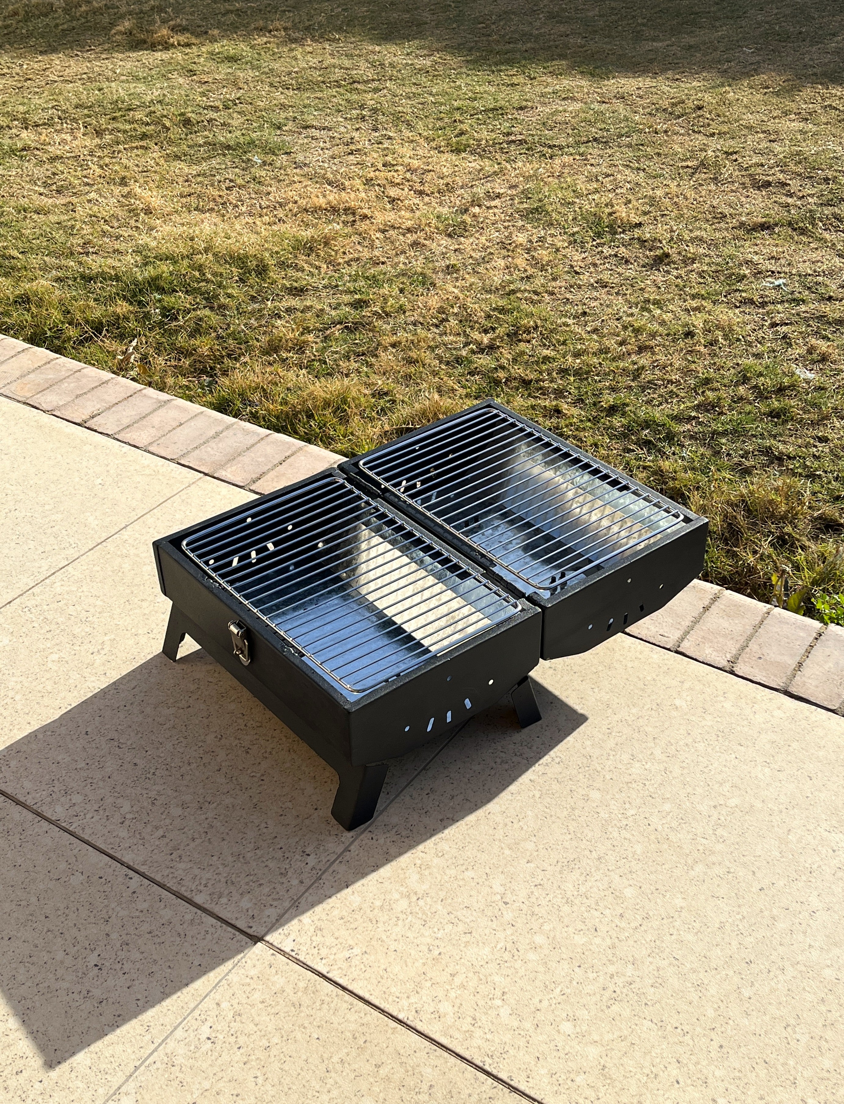 Grillit Double Barrel charcoal grill open and ready for grilling
