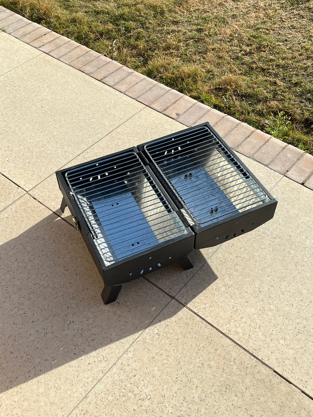 Removable charcoal racks of Grillit Double Barrel portable grill