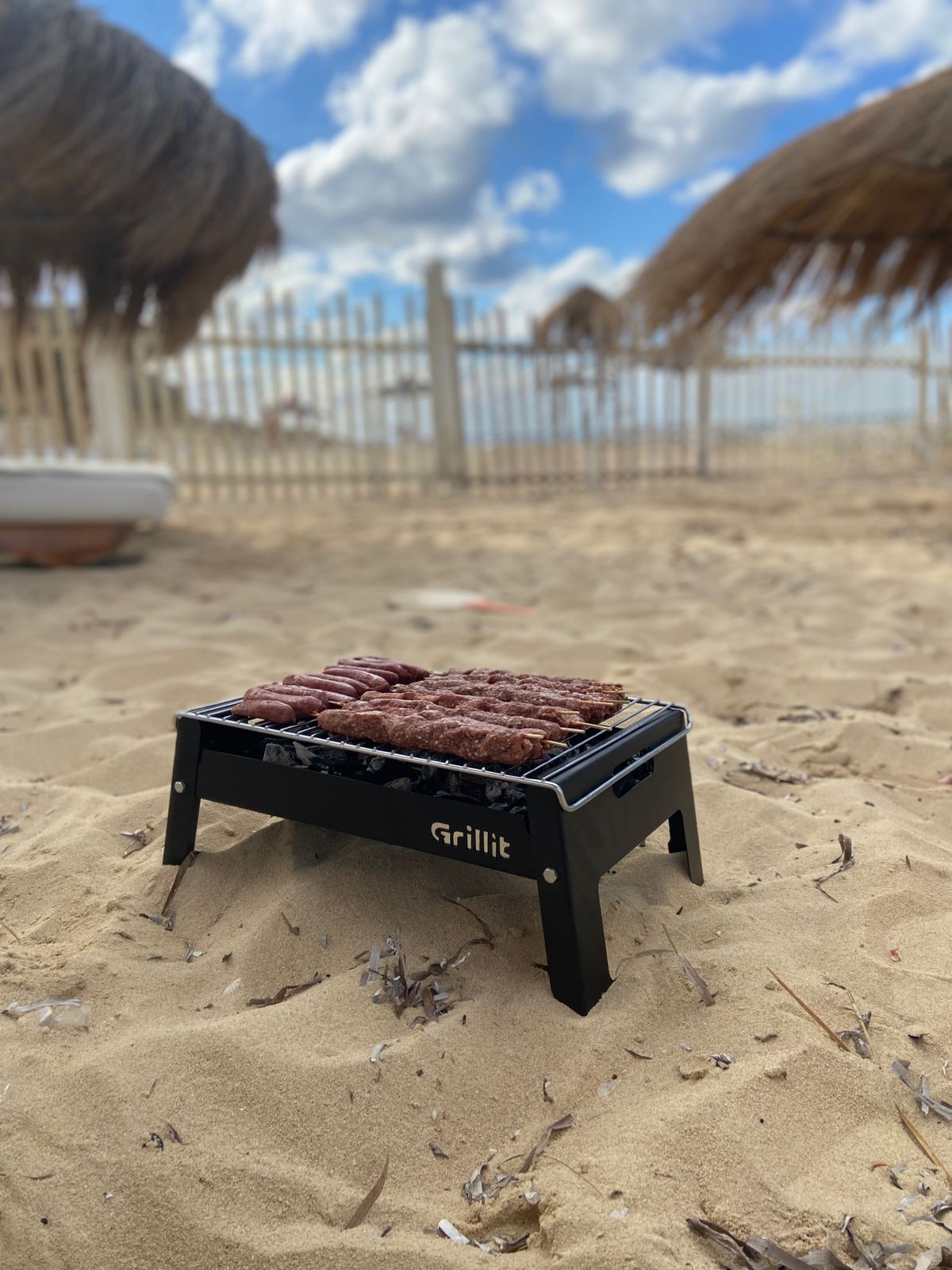 Grillit Slim portable charcoal grill cooking meat evenly on non stick grate