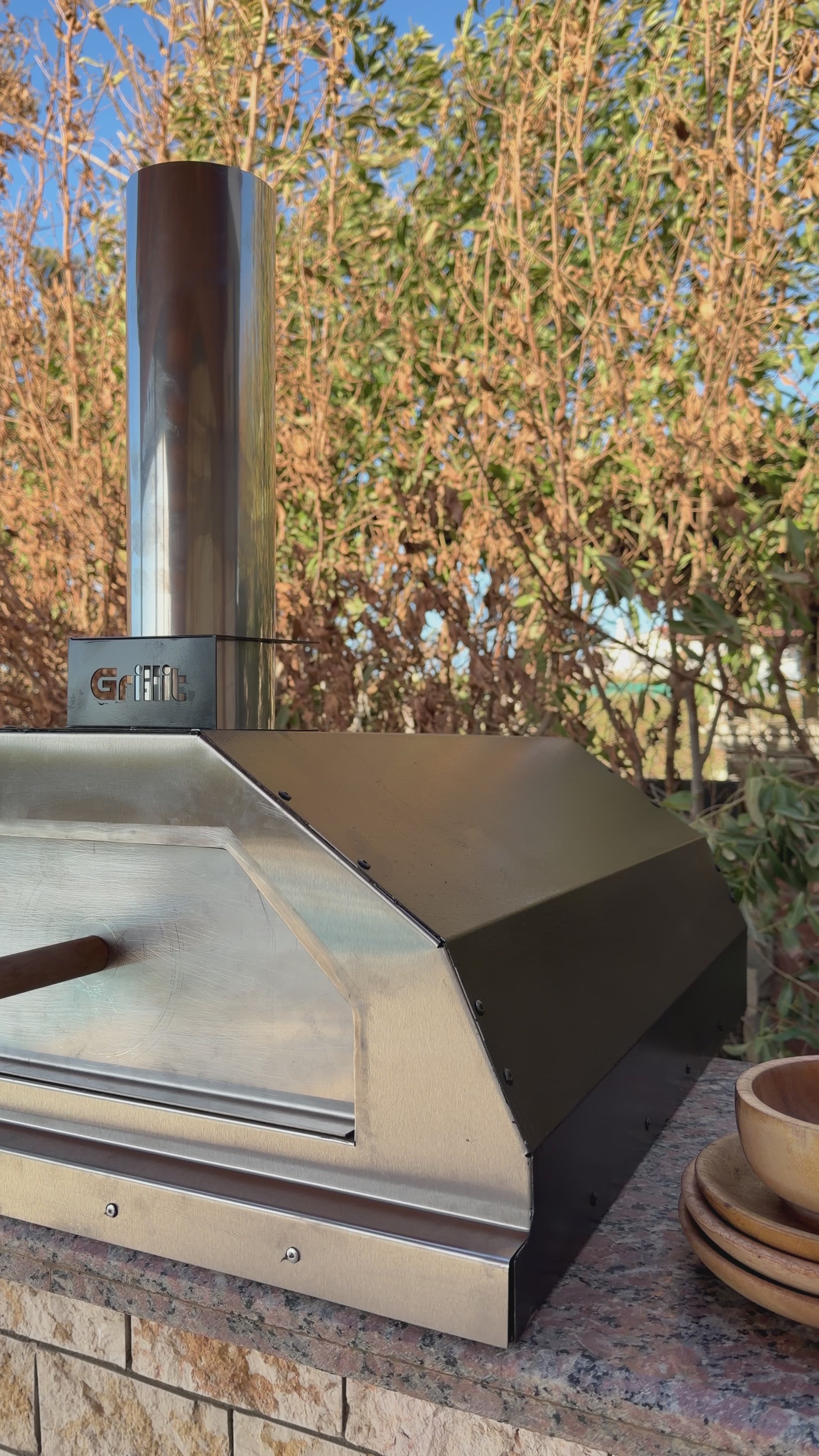 Close up of Grillit wood fired pizza oven stainless steel door and premium carbon steel body